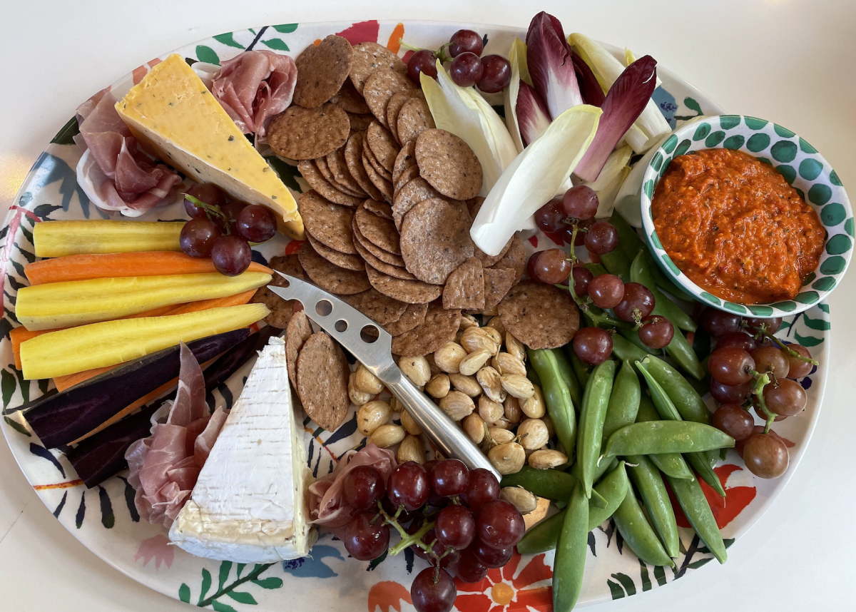 A cheese plate made by my mom sits on a table. Cheese plates appear ordinary, but when customized, they can have the potential to look amazing.